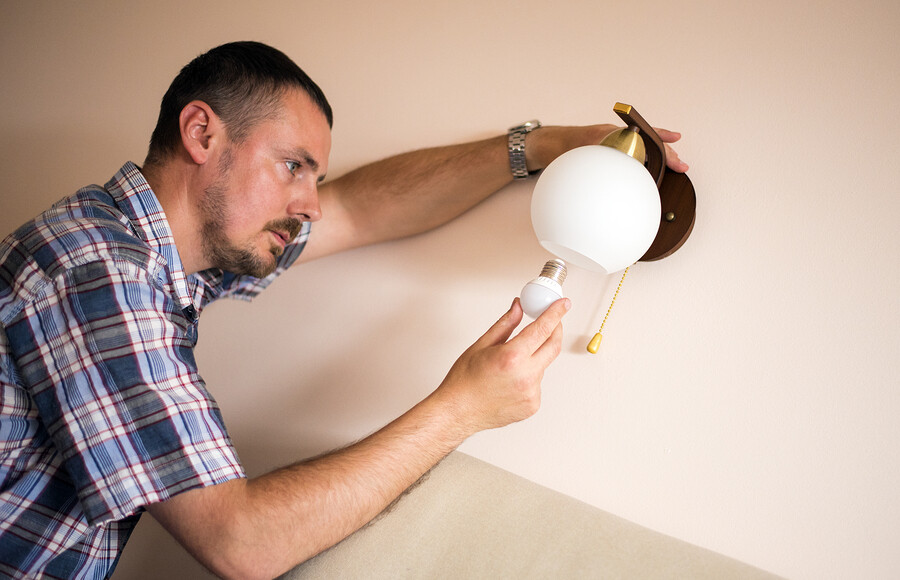 Man Changes Light Bulb-Energy Efficienct Home