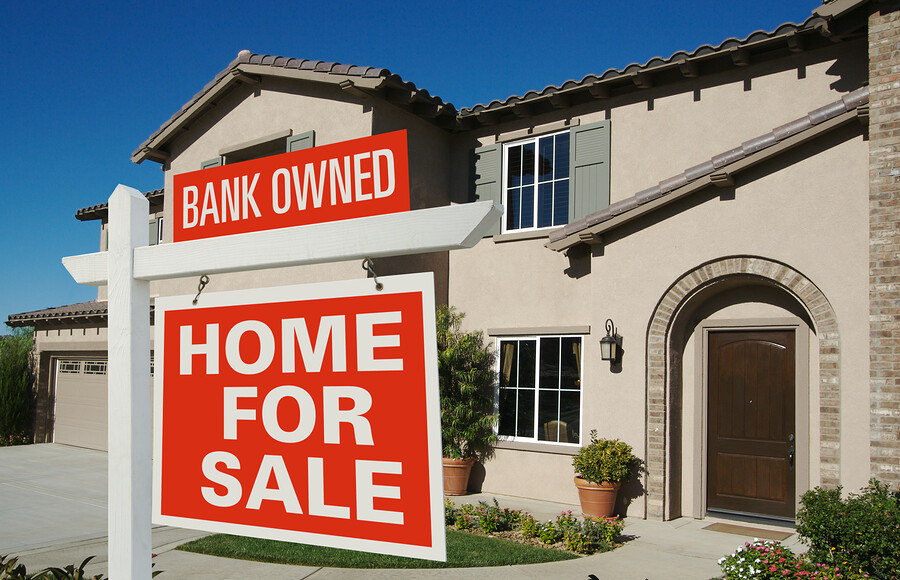 Bank Owned Home For Sale Sign In Front Of New House