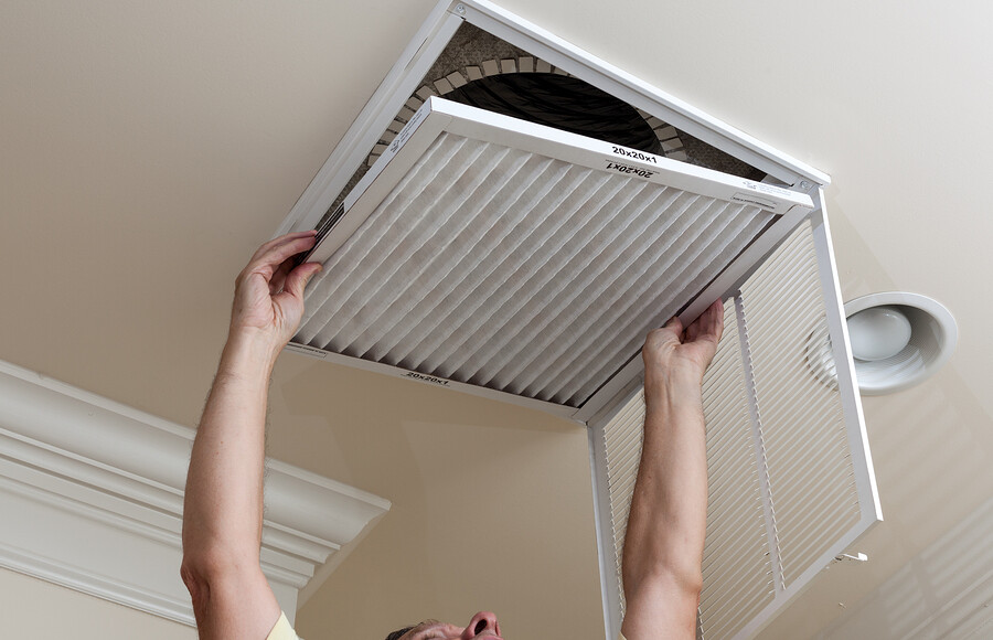 Senior Man Opening Air Conditioning Filter In Ceiling-Las Vegas Remodel and Construction
