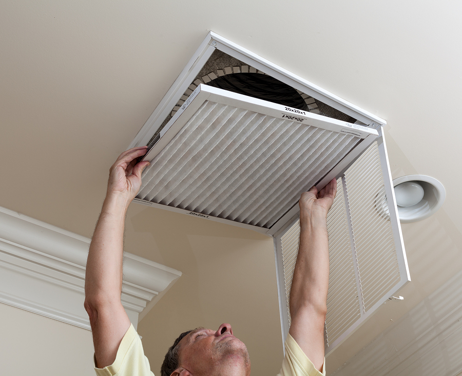 Senior Man Opening Air Conditioning Filter In Ceiling-Las Vegas Remodel and Construction