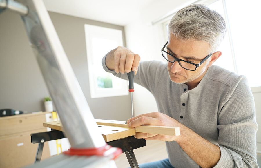 bigstock Man at home assembling DIY fur 214643296