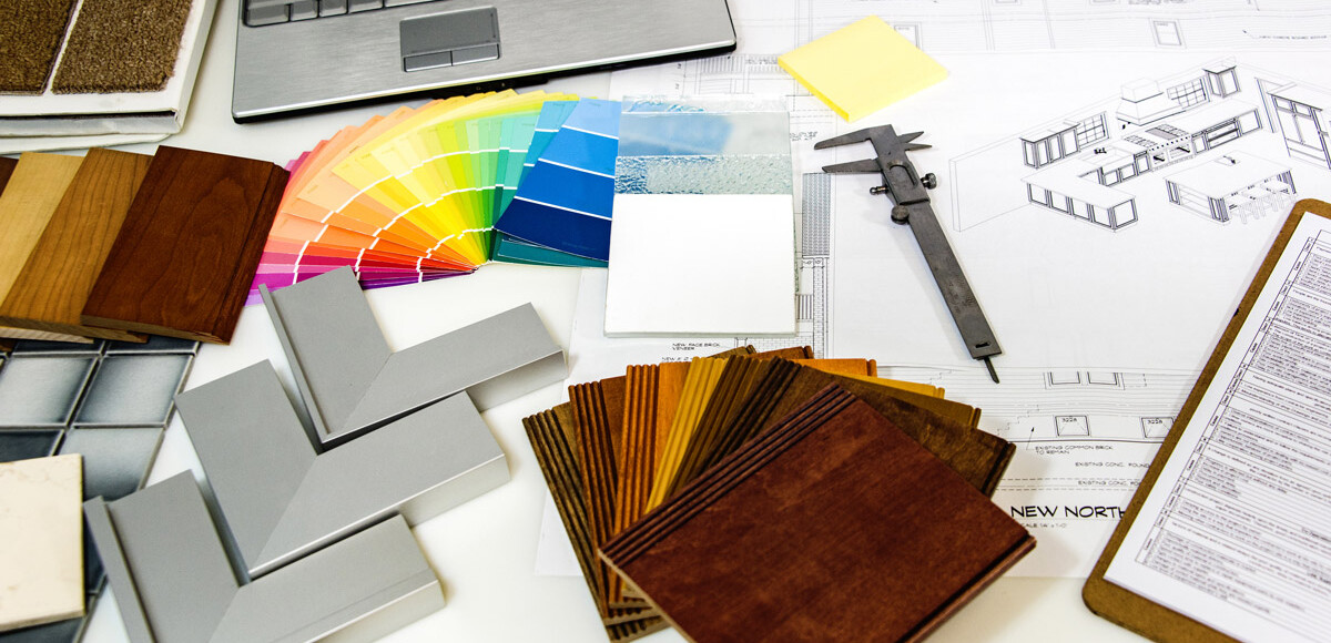 A silver laptop next to home renovation materials